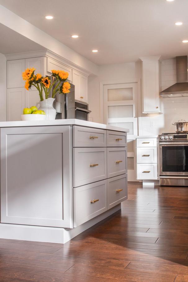 White cabinet with golden details and wooden flooring