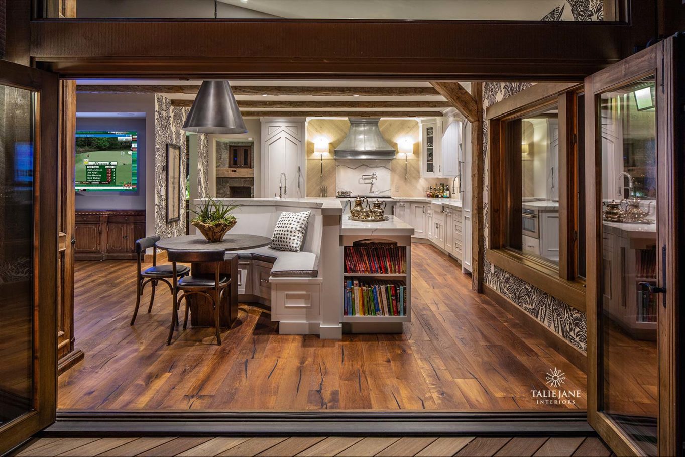 The view of an elaborate wood finish living room and kitchen