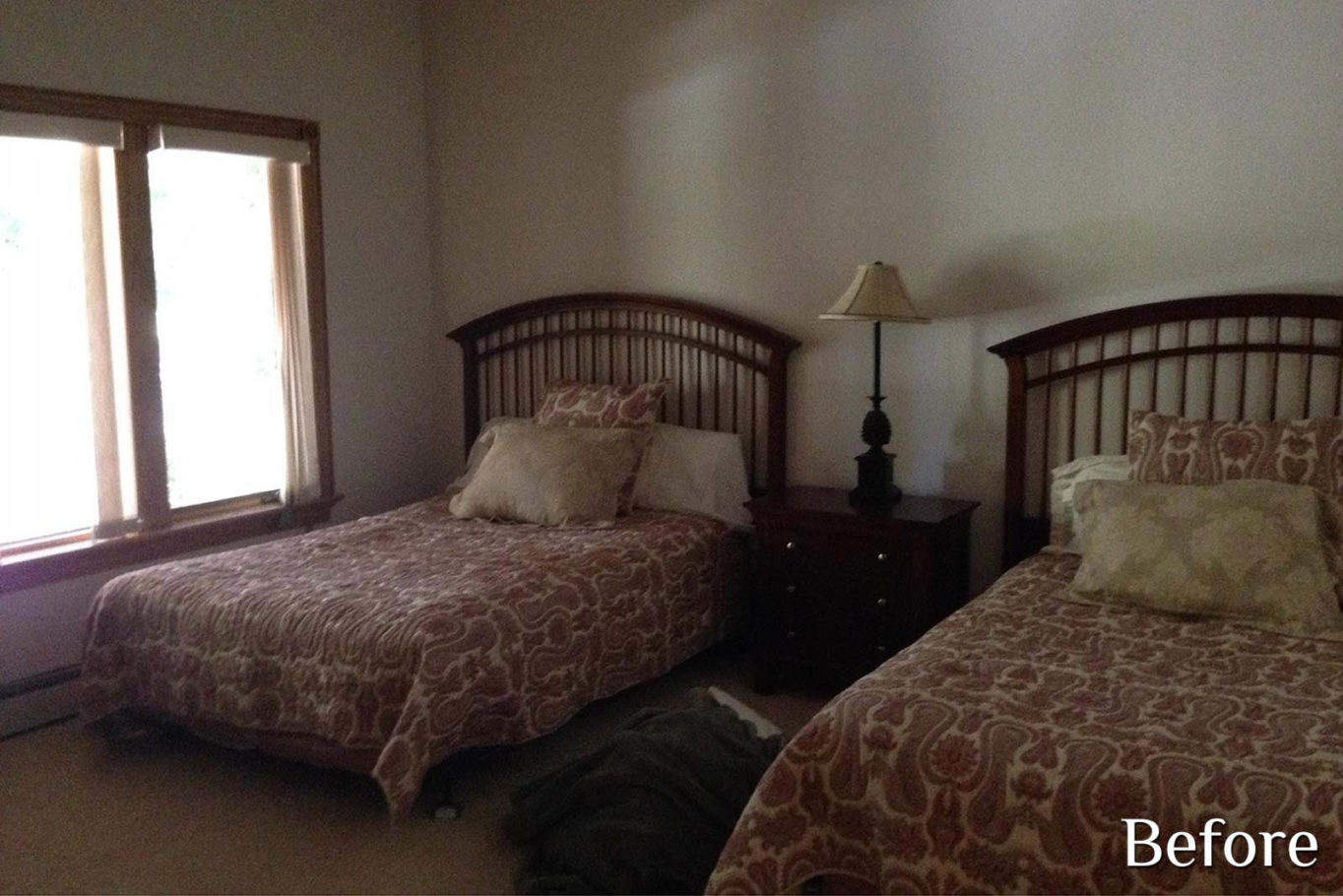 A guest bedroom, two vintage wooden beds, and carpet flooring