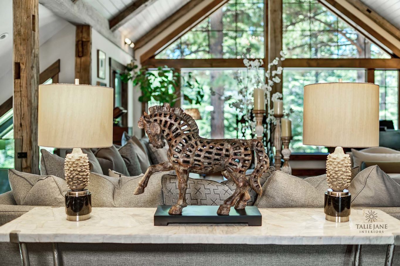 A Farmhouse-style living area with bronze horse statue and lights