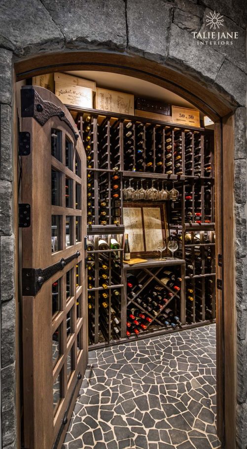A wine seller with stone walls and a wooden storage cabinet